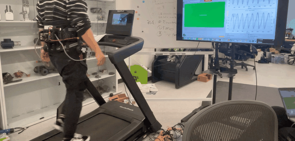 Participant walking on a treadmill while wearing the hip exoskeleton